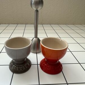 Le Creuset Egg Cup Bundle. 2 cups (gray, orange )+ metal German egg-tops slicer